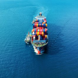 Aerial view of cargo ship with cargo container on sea.